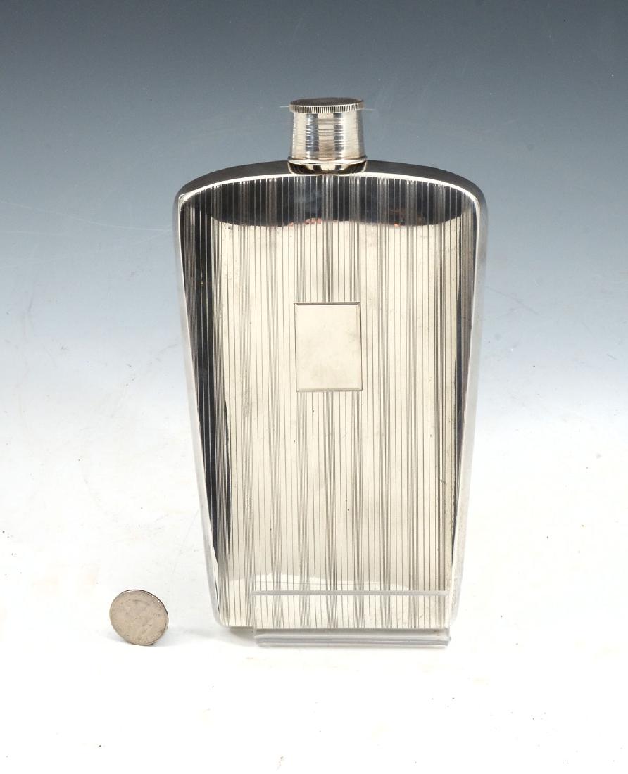 STERLING NAPIER FLASK: LARGE STERLING NAPIER FLASK: Large art deco 16 oz. Sterling Silver having striped design with a rectangle for monogramming. Collapsible jigger lid. Impressed marks to neck & jigger. Approx. 11.10 Troy
