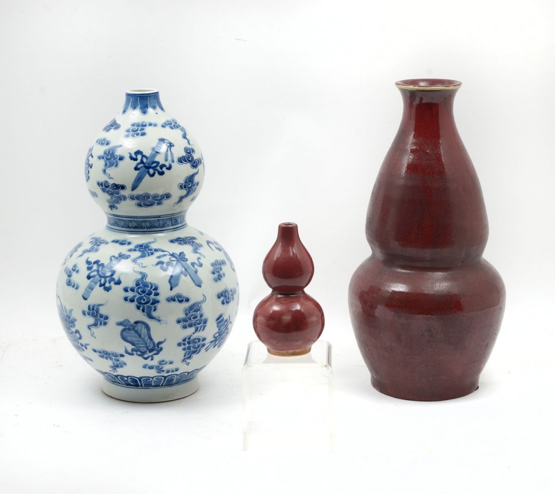3 PIECE CHINESE DOUBLE GOURD VASES: 3 PIECE CHINESE DOUBLE GOURD VASES: Comprising 1-Qing dynasty Chinese red flambe glazed double gourd vase. No makers mark, 1-Chinese double gourd red glazed vase, 1-Qing dynasty Taoist blue & white do