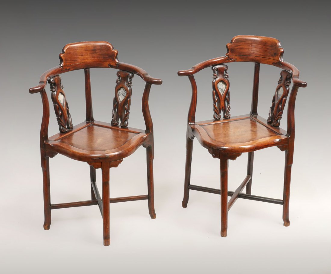 PAIR OF MARBLE INSET CHINESE CORNER CHAIRS: PAIR OF MARBLE INSET CHINESE CORNER CHAIRS: Shaped crest and top rail, carved splats with marble inserts, shaped seat, and X stretcher. Approx. 33.5" h x 24.25" l x 19.5" w.