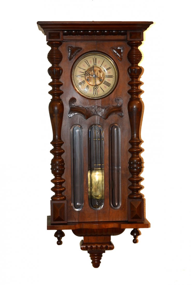 VIENNA REGULATOR WALL CLOCK: VIENNA REGULATOR WALL CLOCK: Vienna Regulator clock having a gold toned foliate medallion in center of white enameled face with Roman numerals and pink foliate design. 3 beveled, vertically elongated 