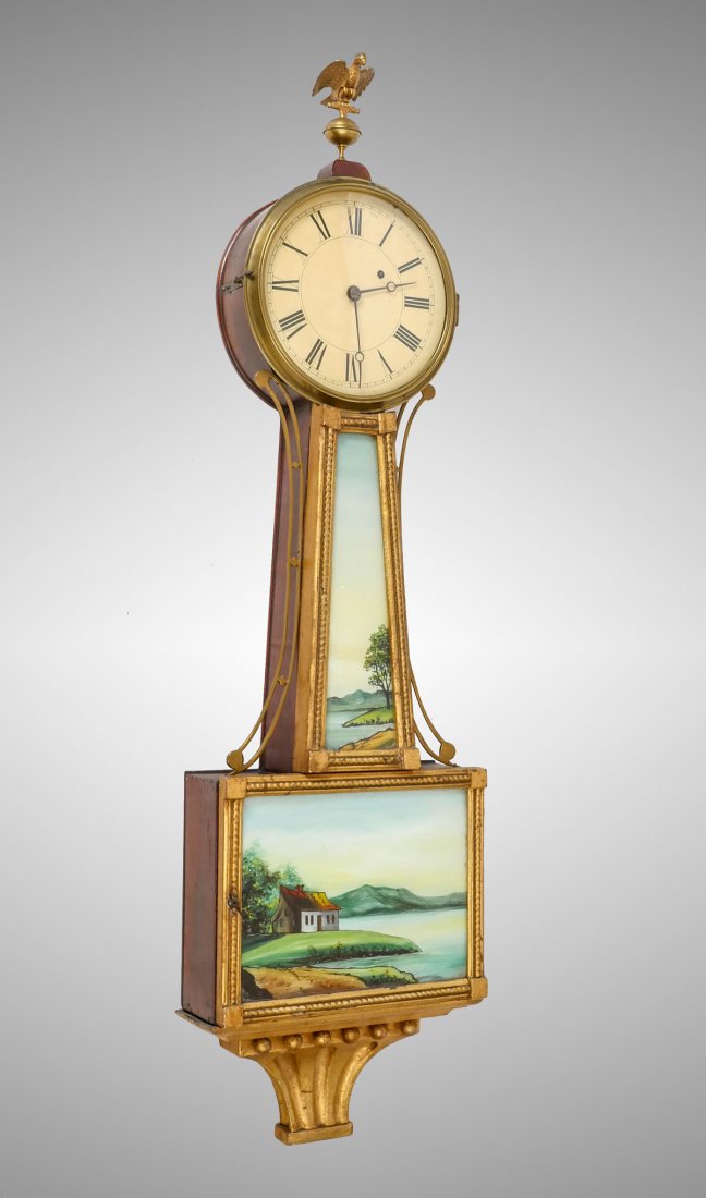 REVERSE PAINTED BANJO CLOCK WITH LAKE SCENE: REVERSE PAINTED BANJO CLOCK WITH LAKE SCENE: A fine 19th C Banjo Clock with revers painted tablet and upright depicting a serene mountainous lakeside view. Approx. 38.5" h x 10.25" l x 4" w.