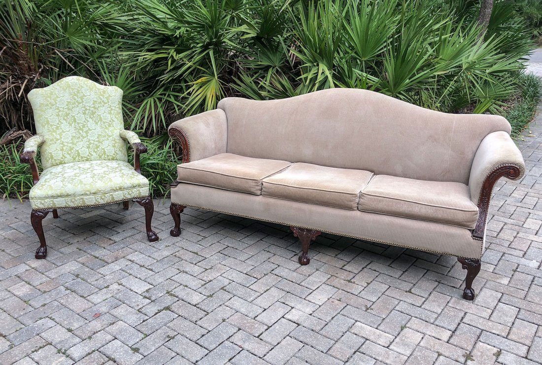 2 PIECE CHIPPENDALE SOFA AND CHAIR: 2 PIECE CHIPPENDALE SOFA AND CHAIR: Comprising a sofa having carved foliate scrolling arm supports, upholstered in a ribbed beige, raised on cabriole legs with claw on ball feet. Approx. 36" h x 78" l
