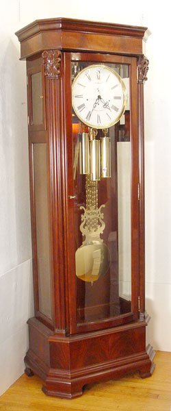 HOWARD MILLER PRESIDENTIAL GRANDFATHER CLOCK: HOWARD MILLER PRESIDENTIAL COLLECTION GRANDFATHER CLOCK: Hayes, model #610-995, floor clock with hand rubbed Windsor Cherry finish, crotch mahogany on pediment and multi tier base. The white dial is a