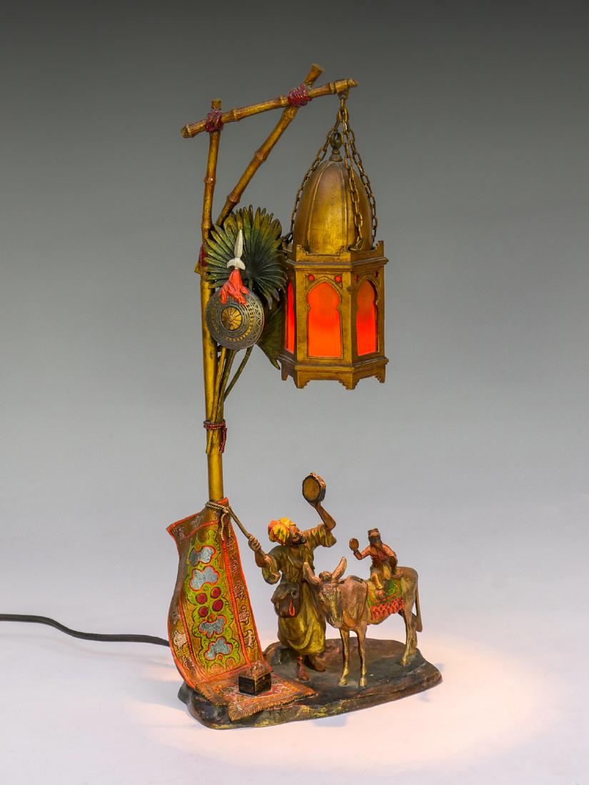 CHOTKA COLD PAINTED BRONZE LAMP: CHOTKA COLD PAINTED BRONZE LAMP: Circa 1910 cold painted bronze figural lamp by Anton Chotka (Austrian 1875-1925). Lamp has a Middle Eastern figure playing the tambourine while his monkey is playing s