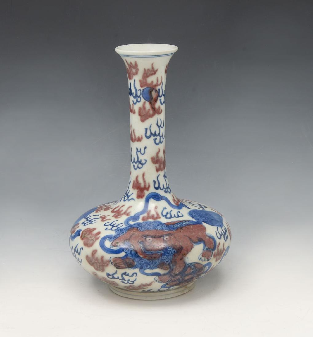 19TH CENTURY FOO DOG VASE: 19TH CENTURY FOO DOG VASE: Chinese 19th C. bottle vase having 2 Foo Dogs with a paw on ball, amongst stylized blue & red flames with 2 Pearl's of Wisdom at neck. Double blue ring to underside. Approx.