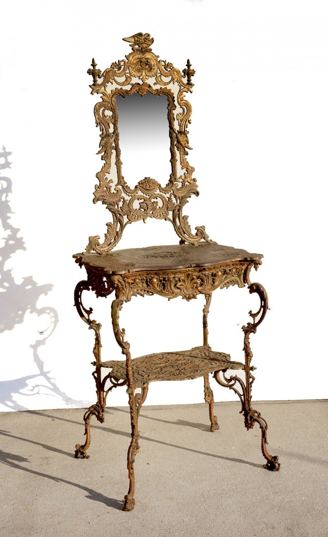 ORNATE VICTORIAN CAST IRON SIDE TABLE & MIRROR: ORNATE VICTORIAN CAST IRON SIDE TABLE & MIRROR: Cast iron victorian side table with mirror, having an overall scrolling foliate design with birds flanking the mirror. Mischievous Cherub scene in cente