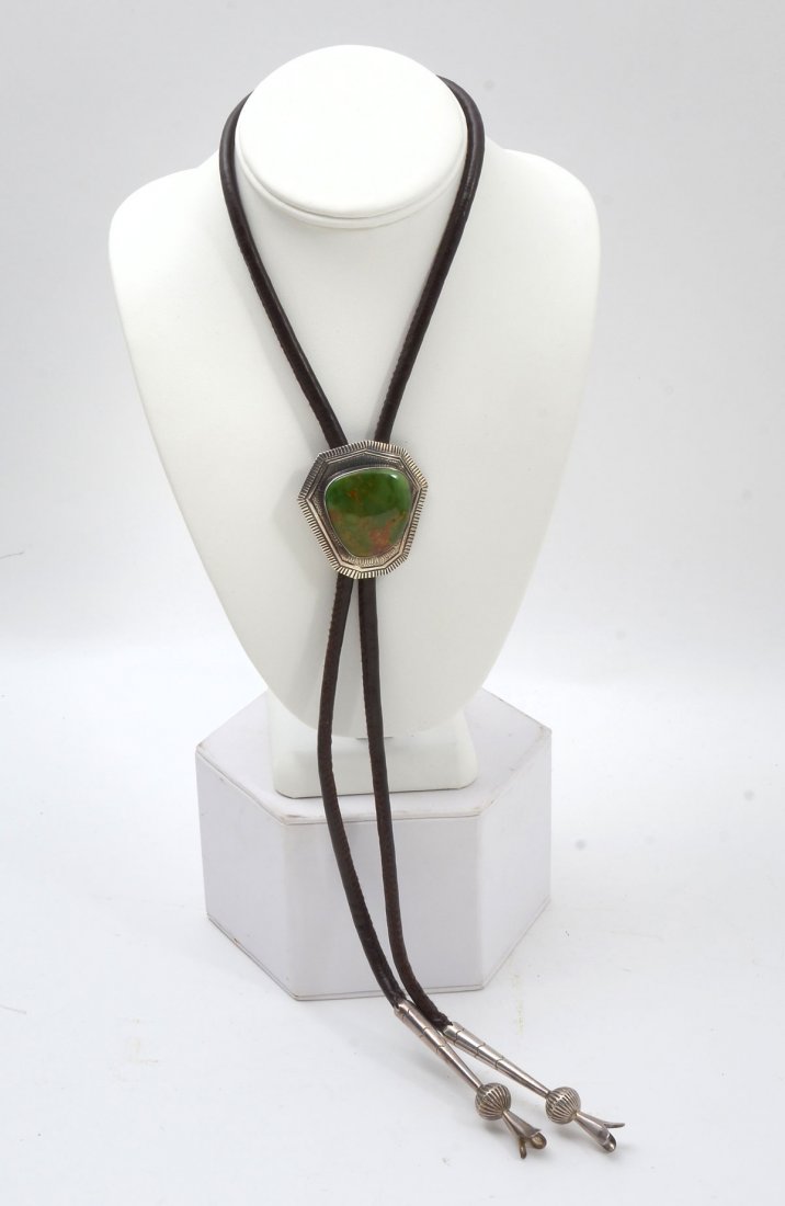 STERLING & TURQUOISE BOLO TIE SIGNED PETER NELSON: STERLING & TURQUOISE BOLO TIE SIGNED PETER NELSON: Sterling & turquoise bolo is handmade by Native American Navajo Peter Nelson. Signed by the artist, bolo measures 2" h x 1.875" w. Leather tie measur