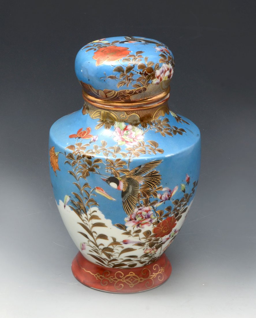 MEIJI PERIOD JAPANESE KUTANI LIDDED JAR: MEIJI PERIOD JAPANESE KUTANI LIDDED JAR: Japanese Kutani lidded jar with blue & white ground having birds flying amongst a hand painted floral & foliate design and heavy gold accenting. 6-character re