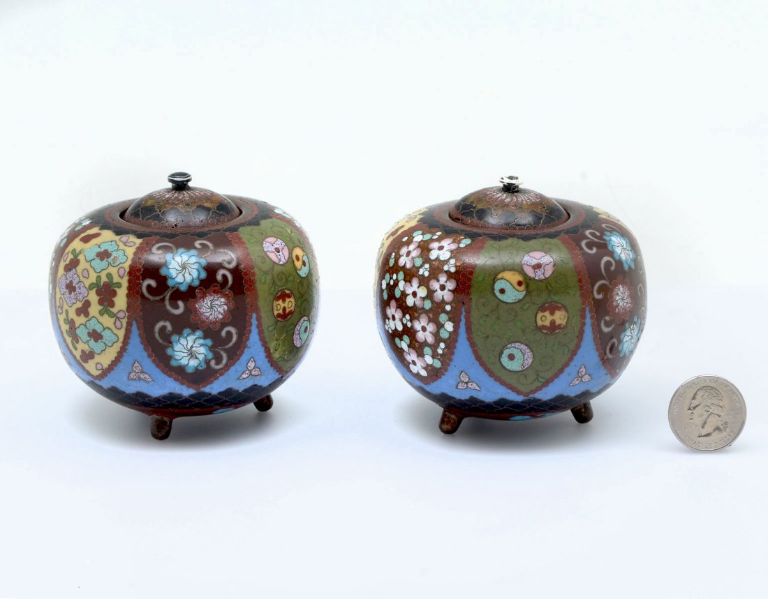 PAIR OF JAPANESE MEIJI CLOISONNE JARS WITH LIDS: PAIR OF JAPANESE MEIJI CLOISONNE JARS WITH LIDS: 2 opposing Meiji period cloisonne lidded jars having an overall floral & Mon motif with Ginbarri work accenting. Approx. 3" h x 3.25" w.