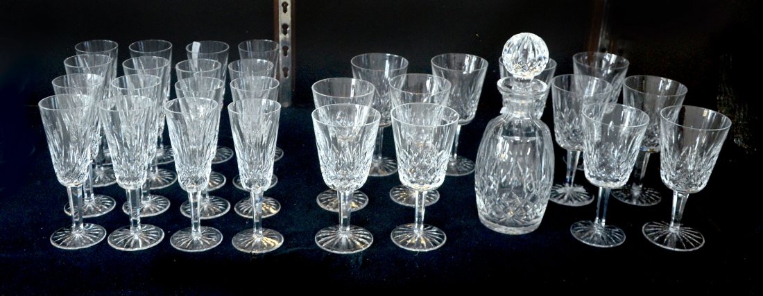 WATERFORD - WINE AND CHAMPAGNEGLASSES & DECANTER: 29 PC LISMORE WATERFORD - WINE, CHAMPAGNEGLASSES & DECANTER: 1) 12 6 7/8'' wine/water glasses; 2) 16 champagne flutes; 3) Lismore decanter. All marked Waterford and like new.