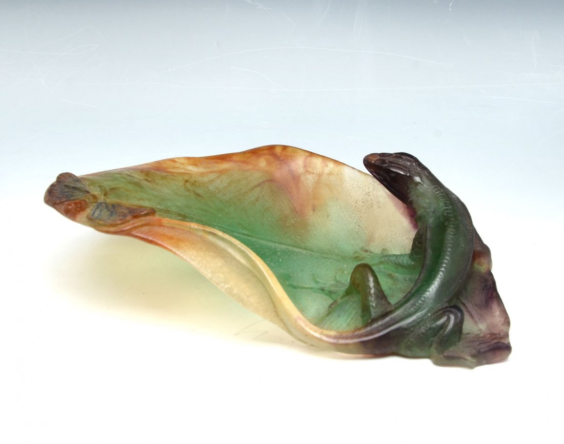 DAUM NANCY PATE DE VERRE CHAMELEON DISH: DAUM NANCY PATE DE VERRE CHAMELEON DISH: Daum Nancy Pate De Verre leaf form dish having a chameleon being teased by a moth resting at his tail. Signed in pontil, "Daum, France. Approx. 2.25" h x 8" l