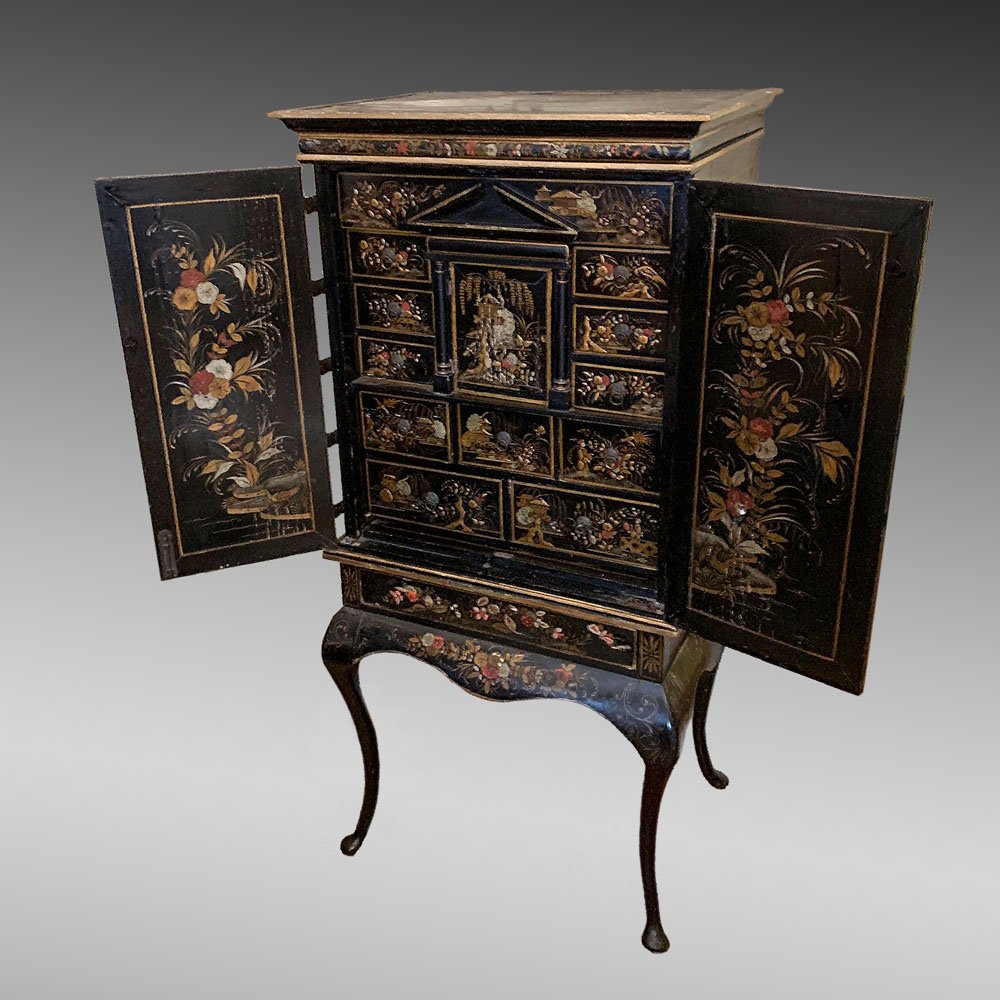 CHINOISERIE DECORATED CABINET: CHINOISERIE DECORATED CABINET: Chinoiserie decorated cabinet having a raised Chinese motif painted at doors. Doors open to reveal a 11 drawer, 1 door interior with a hidden drop compartment, 2 hidden 