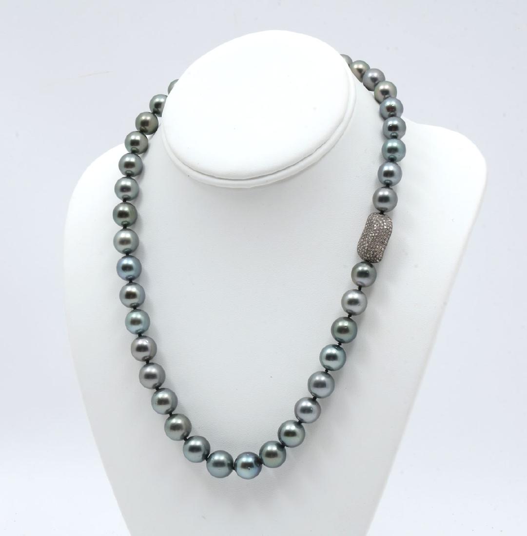 SOUTH SEAS BLACK PEARL NECKLACE WITH 14K CLASP: SOUTH SEAS BLACK PEARL NECKLACE WITH 14K CLASP: 19.75'' single strand of graduated cultured Tahitian pearls with each pearl individually knotted. 39 pearls range in size from 10-12mm with an excellent