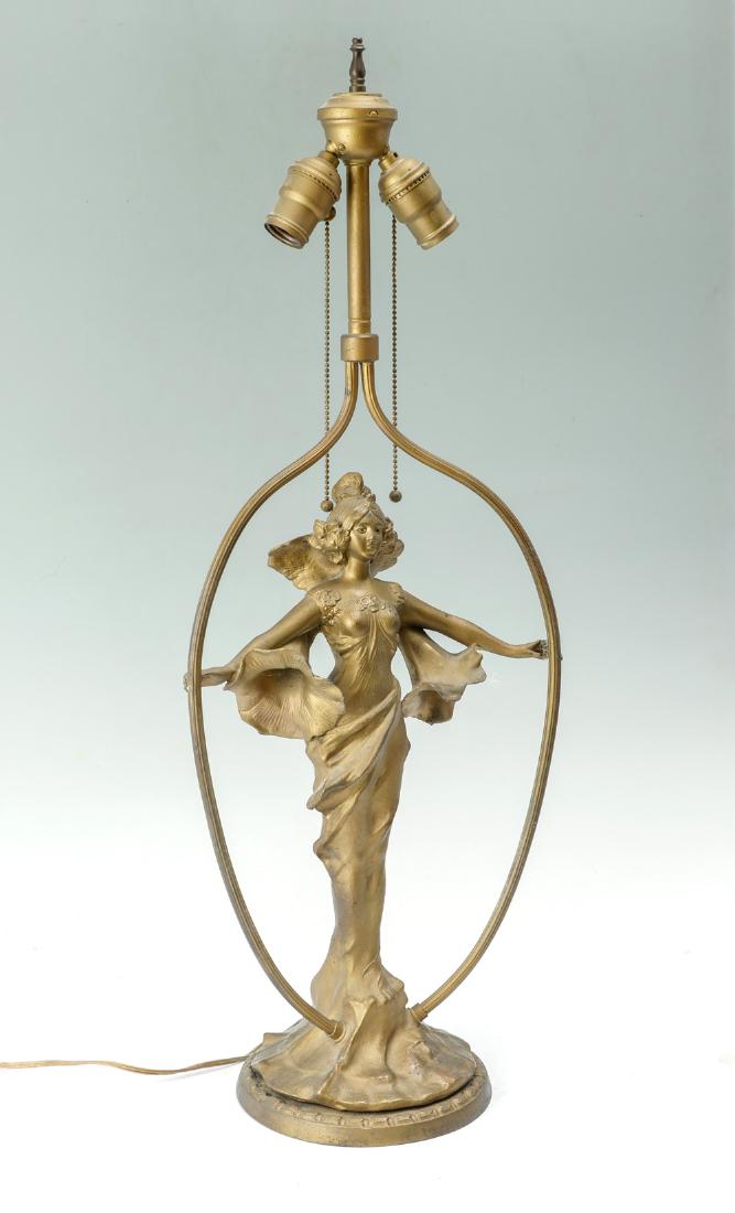 P.L.B. & G CO. FEMALE CAST ART NOUVEAU LAMP: P.L.B. & G CO. FEMALE CAST ART NOUVEAU LAMP: Pittsburgh 2 light P.L.B. & G Co. gold toned art nouveau lamp having a woman in center flanked by fluted supports. Underside marked P.L.B. & G. Co., 1836. 
