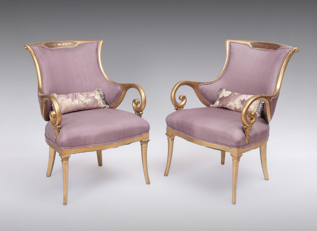 PAIR NOUVEAU ERA SCROLL ARM CHAIRS: PAIR NOUVEAU ERA SCROLL ARM CHAIRS: 2 armchairs having an inlaid foliate design at crest rail. Gold colored scrolling designed frame work with foliate accents, upholstered in purple fabric. Raised on 