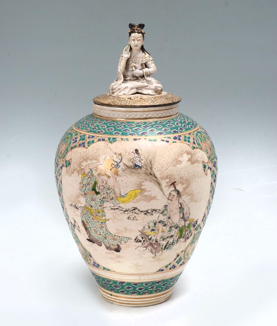 KOREAN FIGURAL LIDDED JAR: KOREAN FIGURAL LIDDED JAR: Circa 1900 Korean jar with a surmounting female goddess in a resting position upon a pierced lid. Body having 2 windows with immortal & Auspicious scenes. Phoenix medallions