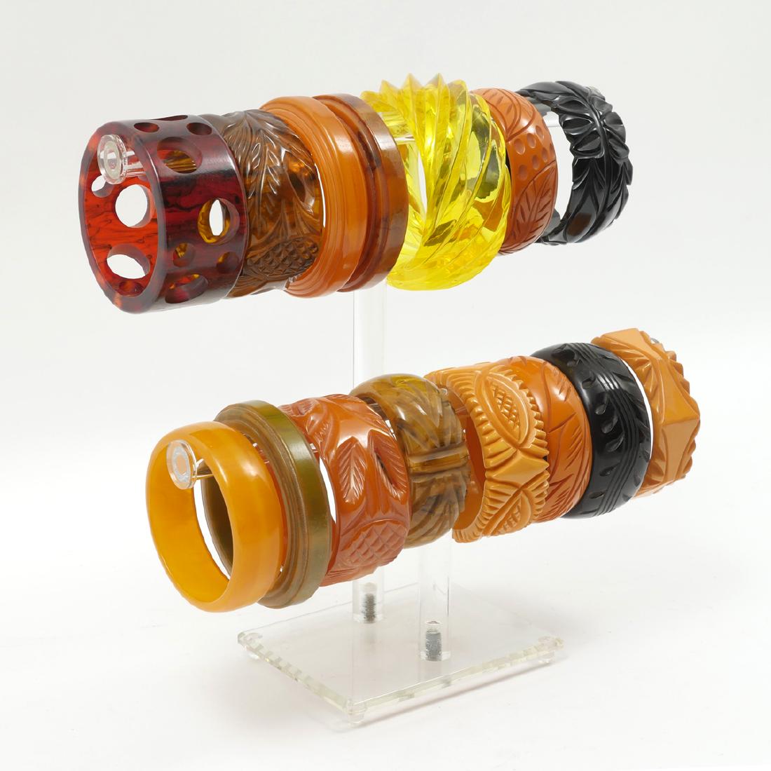 15 BAKELITE BRACELETS: 15 BAKELITE BRACELETS: Beautiful collection of Bakelite bracelets including many carved thick bangles, some slimmer, and one with swiss cheese holes, one with a hinge open. Great for mixing and matchi