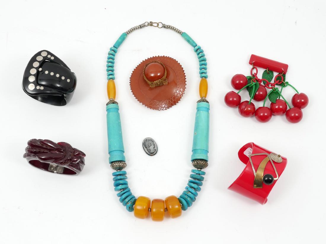 7 PIECE BAKELITE LOT: 7 PIECE BAKELITE LOT: Fun and interesting lot. 1) 24" necklace with turquoise color beads accented with yellow beads; 2) Red cuff bracelet with metal accents and black bead measures 5.75" with 1" open