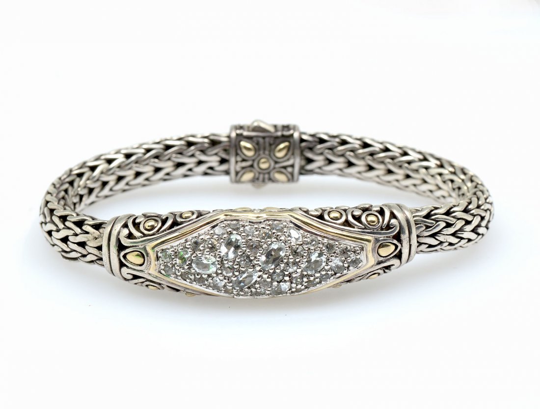 JOHN HARDY STERLING AND 18K BRACELET: JOHN HARDY STERLING AND 18K BRACELET: Sterling silver bracelet is beautifully crafted in a woven pattern with 18K yellow gold accents. This bracelet is a size M. Stamped with the John Hardy hallmark,
