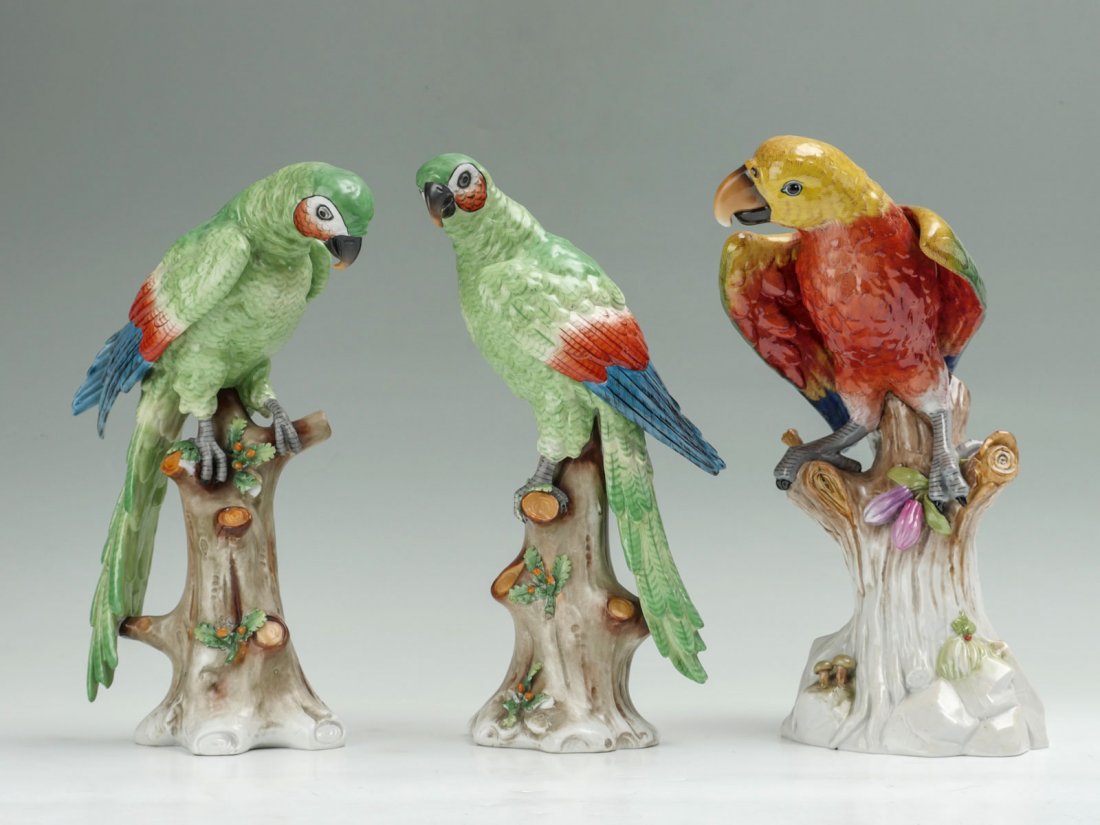3 ITALIAN CAPODIMONTE PORCELAIN PARROTS: 3 ITALIAN CAPODIMONTE PORCELAIN PARROTS: 1) Beautiful pair of hand painted 14" green porcelain parrots, each on a tree trunk; 2) 14" red porcelain parrot with gold head, also sitting on a tree perch.