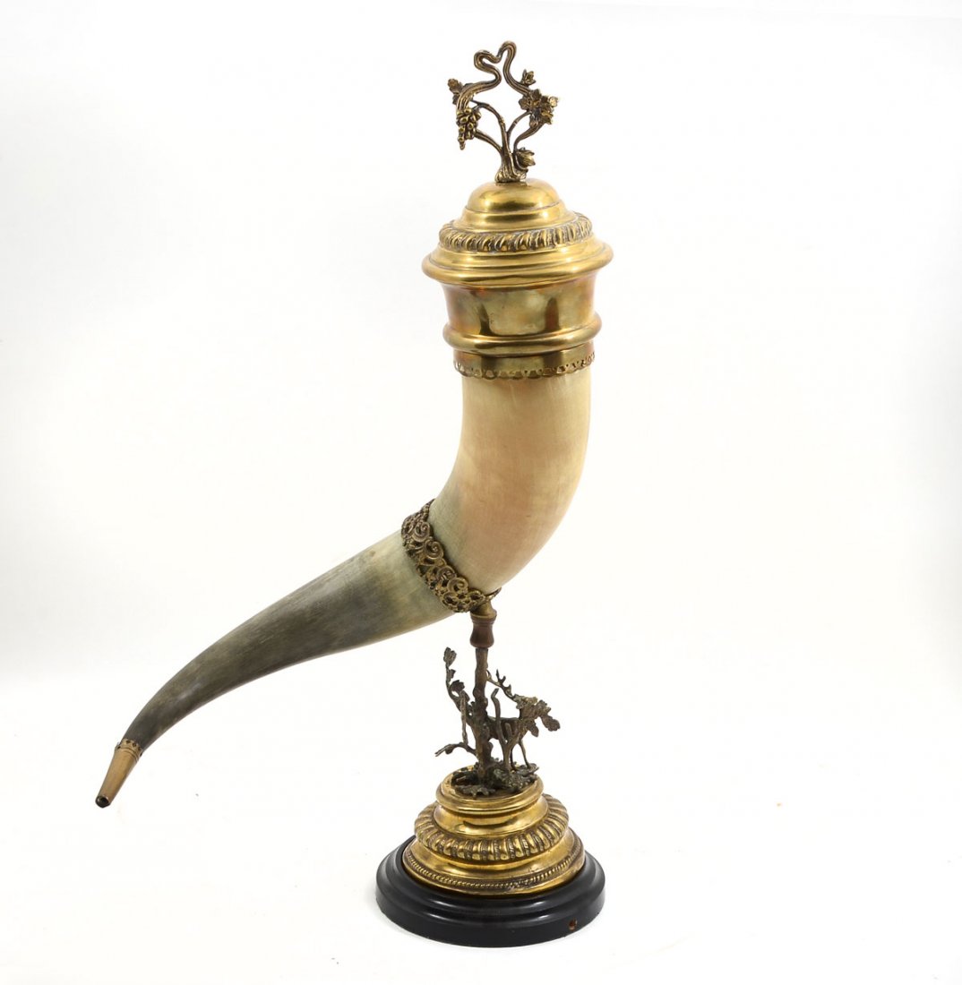 AUSTRIAN LIDDED DRINKING HORN: AUSTRIAN LIDDED DRINKING HORN: Large Austrian drinking horn with a mounted scrolling foliate design and mounting pin. Pin rests in the base having deer amongst foliate, mounted on a brass colored stan