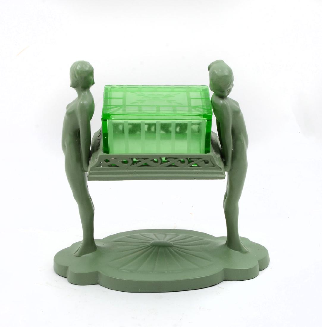 FRANKART URANIUM GLASS CIGARETTE BOX: FRANKART URANIUM GLASS CIGARETTE BOX: Art deco Frankart base having 2 opposing nude women holding a pierced support that has an etched green depression glass uranium cigarette box. Approx. 9.25'' h x
