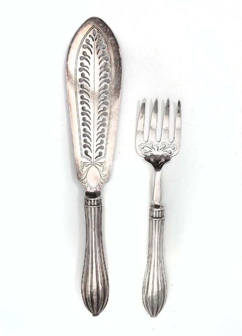 STERLING FISH SERVING SET MARTIN HALL AND CO.: STERLING FISH SERVING SET MARTIN HALL AND CO.: Approx. 5.47 weighable Troy ounces. Comprising; 1- Fish server & 1- Fish fork, both having a fluted handle with openwork & scrolling foliate design. Made