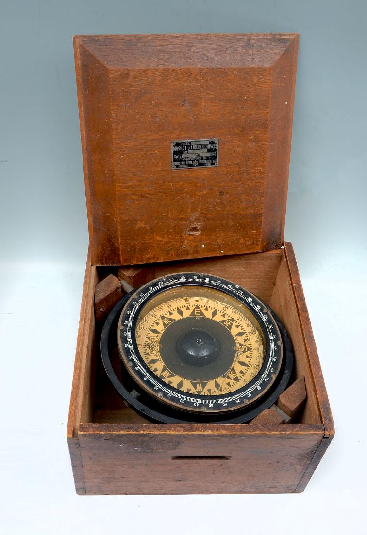 MAGNETIC LIQUID COMPASS IN BOX: MAGNETIC LIQUID COMPASS IN BOX: Gyroscopic magnetic liquid compass in a wooden box, made by the Nunotani Keiki, Dec. 1960, Model BS-7. Approx. 6.75'' h x 11.75'' l x 12.25'' w.