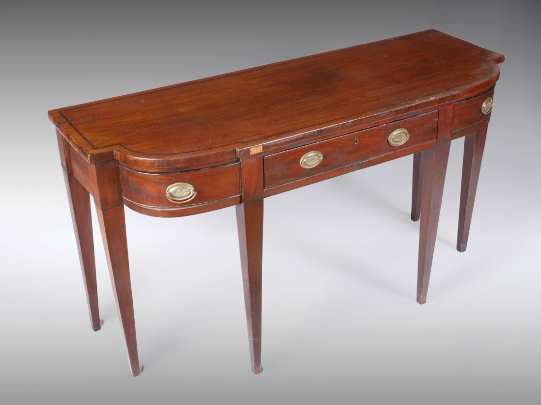 BRITISH HEPPLEWHITE STYLE SIDEBOARD: BRITISH HEPPLEWHITE STYLE SIDEBOARD: Early British banded 3 drawer sideboard in the manner of Hepplewhite having feather medallion bail handles. Raised on tapered square legs. Approx. 33.5" h x 62" l 