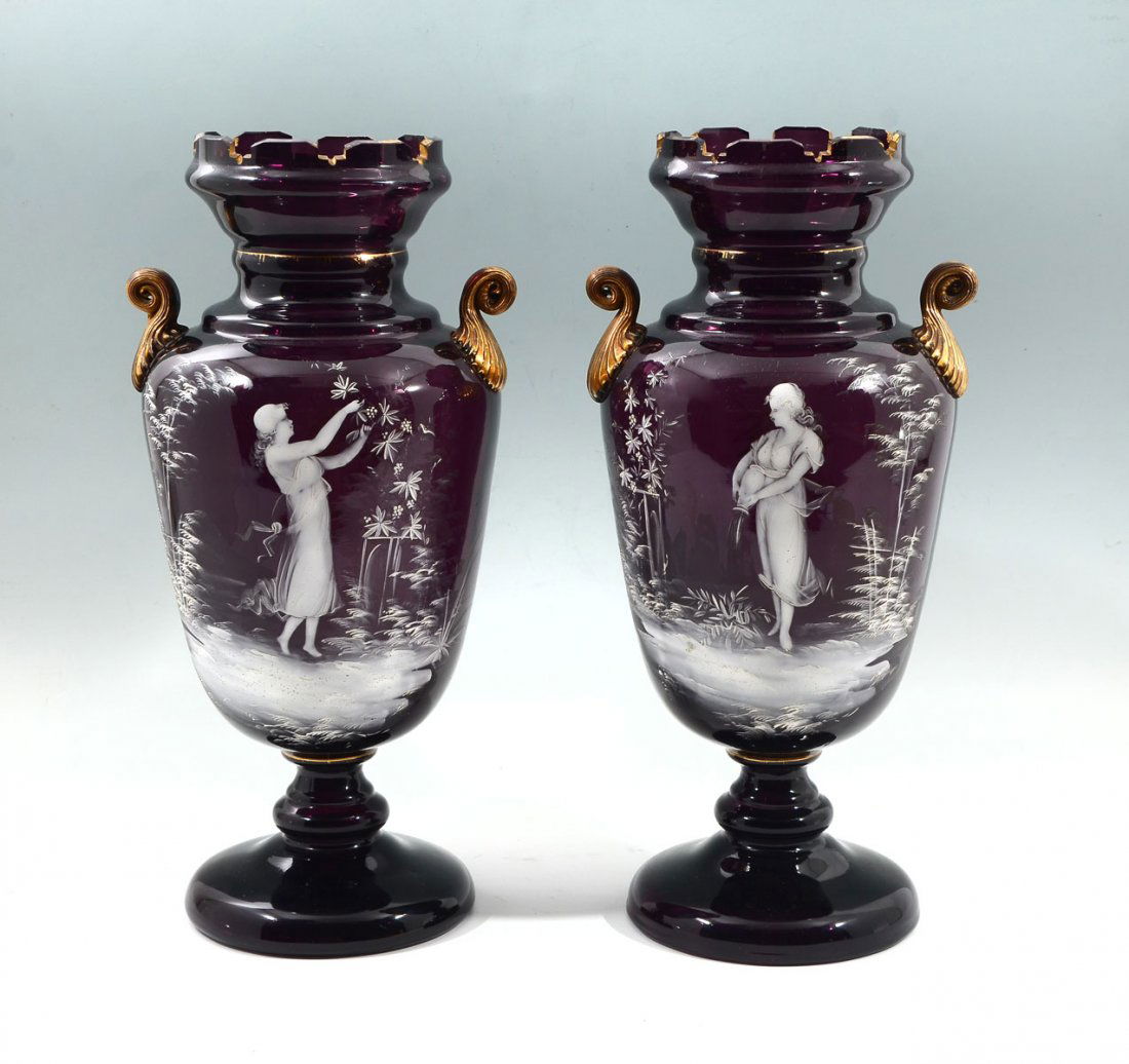 2 MARY GREGORY AMETHYST VASES: 2 MARY GREGORY AMETHYST VASES: 2 Mary Gregory Amethyst vases having hand-painted white enameled opposing scenes with a female in center amongst foliate at the observe and a foliate design at the verso