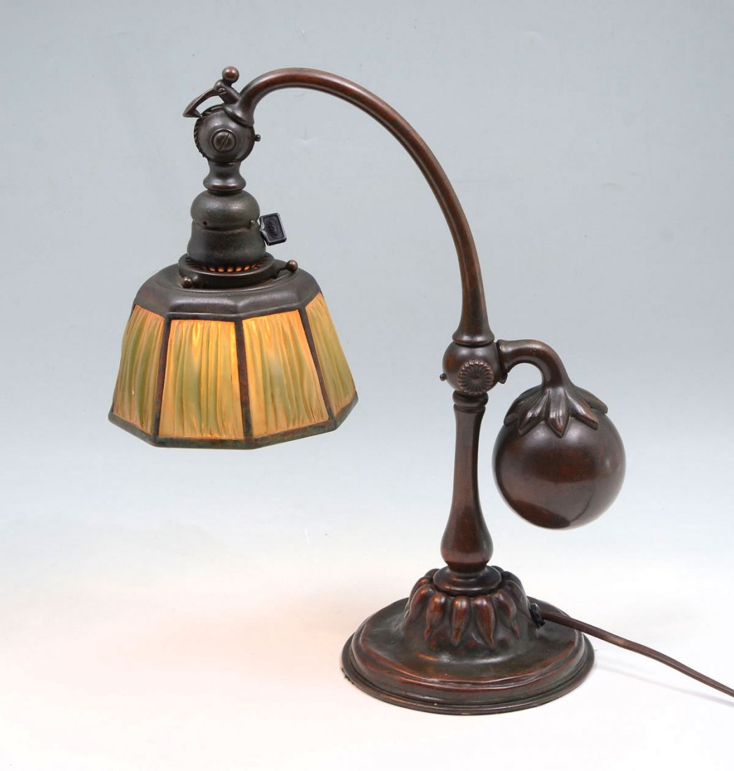 TIFFANY STUDIOS LINEN FOLD COUNTER BALANCE LAMP: TIFFANY STUDIOS LINEN FOLD COUNTER BALANCE LAMP: Bronze Tiffany Linen Fold counter balance desk lamp having a floriform base and weight mount. Neck has a locking mechanism to raise lamp shade to desir