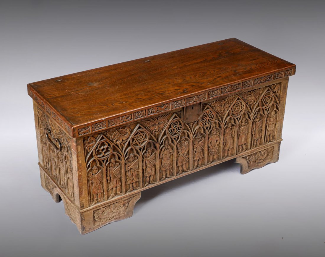 EARLY HEAVILY CARVED OAK GOTHIC STYLE COFFER: EARLY HEAVILY CARVED OAK GOTHIC STYLE COFFER: Heavily carved early coffer having figures in arches with Celtic symbols above. Carved Greenman faces, upper border having alternated floral & mythical be