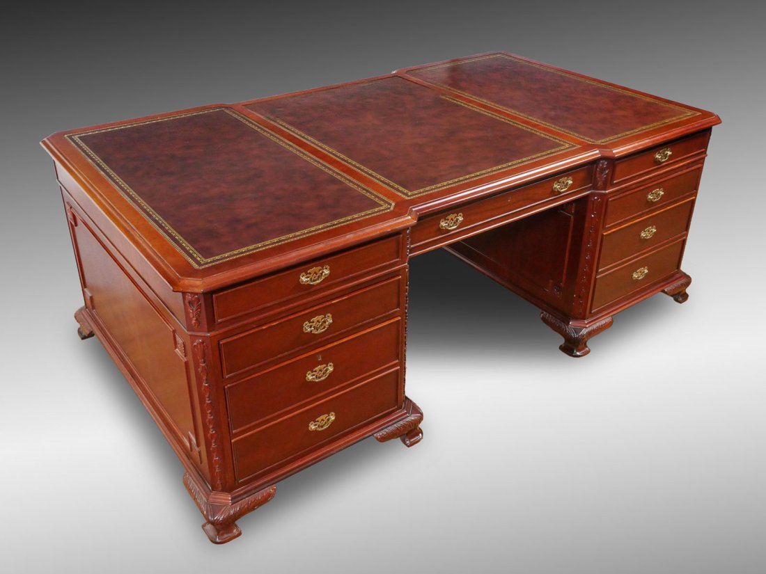 LEATHER TOP PARTNERS DESK: LEATHER TOP PARTNERS DESK: Gold embossed leather top partners desk having 7 drawers at one side. Other side has 3 drawers over 2 doors. Tapered foliate design at corners, carved foliate knees with bra