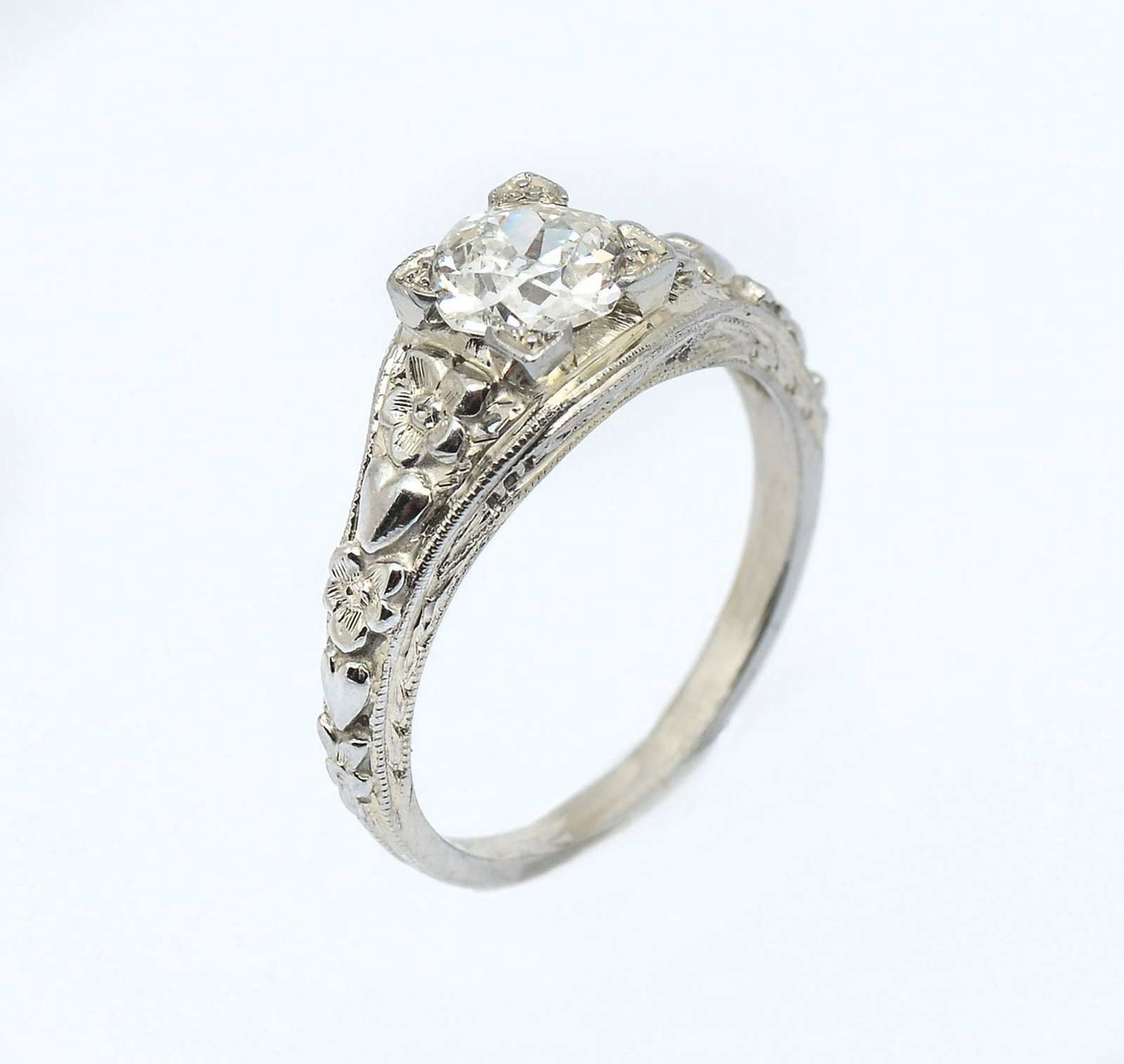 18K OLD MINE SOLITAIRE DIAMOND RING: 18K OLD MINE SOLITAIRE DIAMOND RING: Old mine cut diamond approx .73 CT rated SI2 in clarity and in color set in white gold. Size 5. Approx 3.0 grams. Repousse with filigree gallery. Sold with current