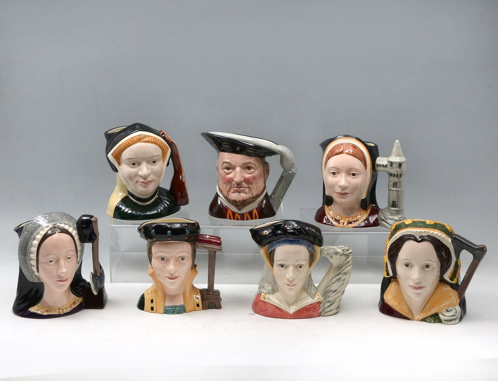 7 ROYAL DOULTON MUGS HENRY VIII AND HIS 6 WIVES: 7 ROYAL DOULTON MUGS HENRY VIII AND HIS 6 WIVES: Comprising; 1- King Henry VIII, #D6642, 1-Catherine Parr, #D6664, 1- Catherine Howard, #D6645, 1- Jane Seymour, #D6646, Anne of Cleves, #D6653, 1- Cath