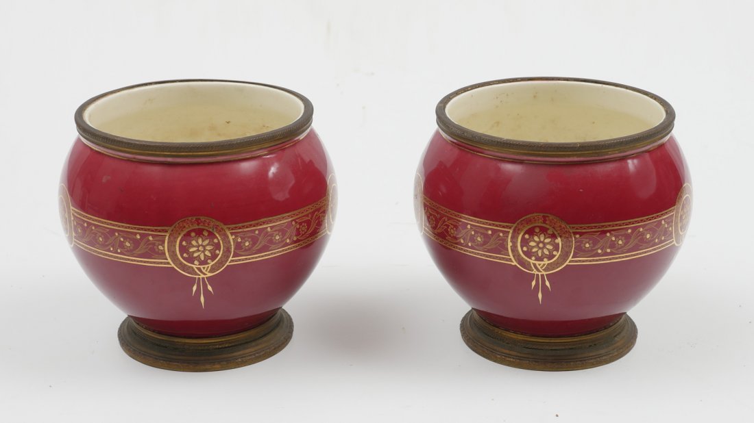 PAIR OF BOCH FRERES CACHE POTS: PAIR OF BOCH FRERES CACHE POTS: 2 Boch Freres dark red round cache pots having Gilt metal rims & feet. Floral medallions & scrolling foliate encompassing gold design. Undersides bares the Black Boch F