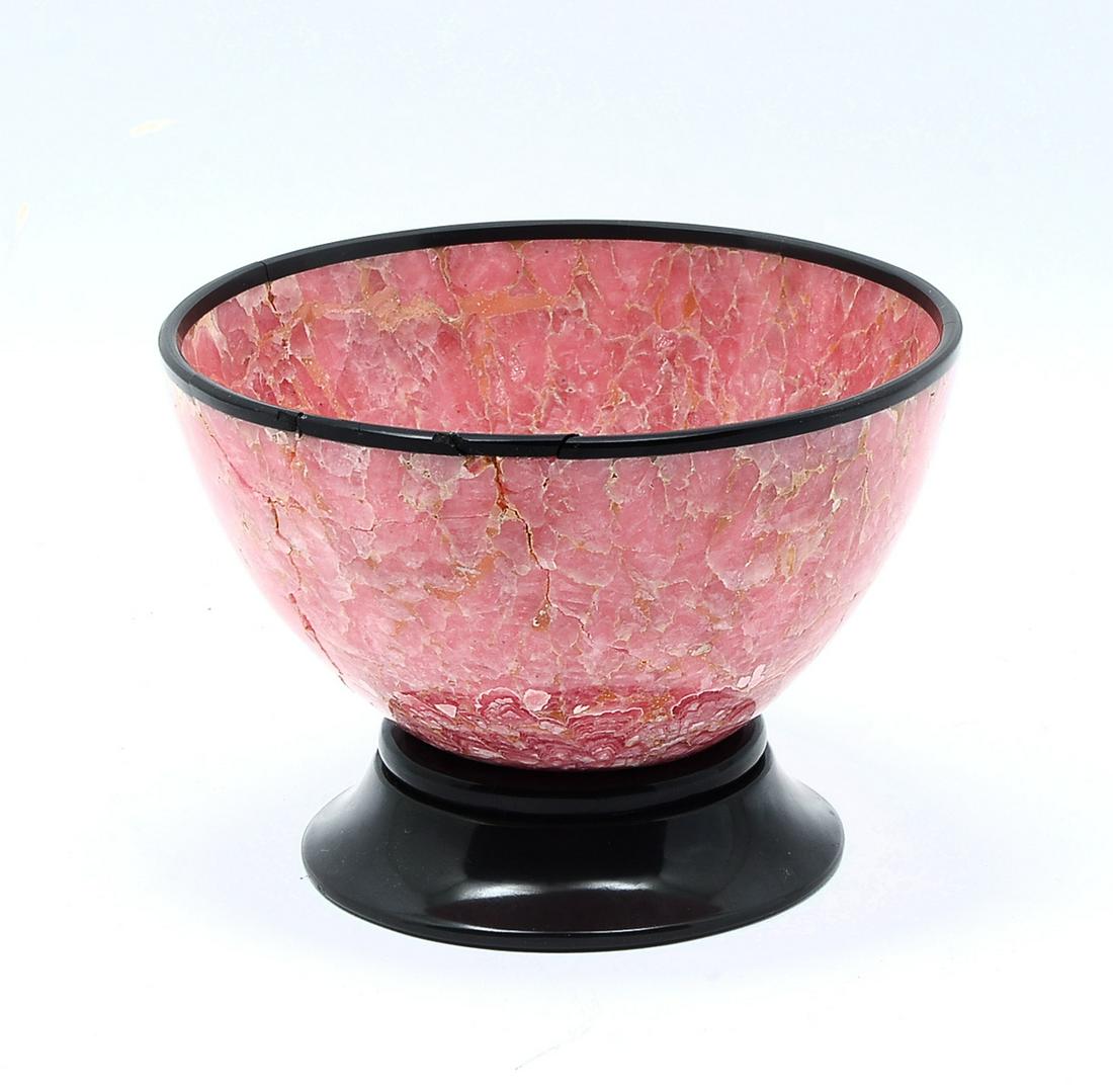 ARGENTINIAN SEMI-PRECIOUS RHODOCHROSITE ART BOWL: ARGENTINIAN SEMI-PRECIOUS RHODOCHROSITE ART BOWL: Ground & polished Semi-precious Rhodochrosite art bowl from Argentine having a polished black rim & foot. Approx. 4.25" h x 6" w.