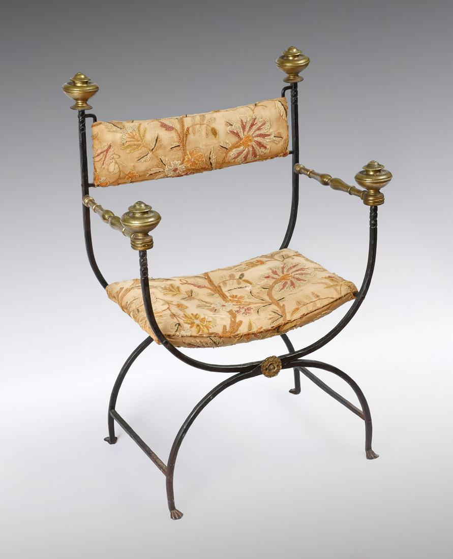 19TH CENTURY ITALIAN WROUGHT IRON BRASS CAMPAIGN C: 19TH CENTURY ITALIAN WROUGHT IRON BRASS CAMPAIGN CHAIR: Italian Renaissance style wrought iron folding chair in the Savonarola form, having turned brass finials & arms with a brass floral medallion at