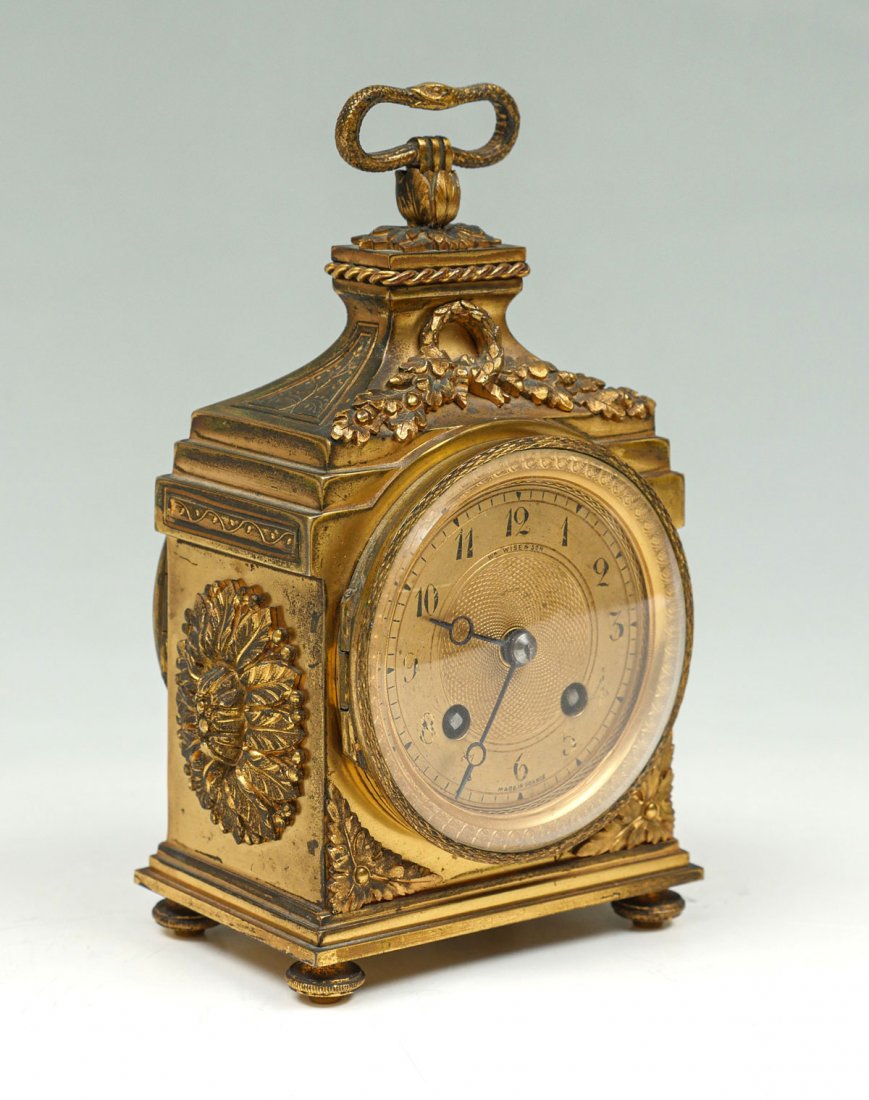 FRENCH P. GRENON CAPTAIN'S GILT CARRIAGE CLOCK: FRENCH P. GRENON CAPTAIN'S GILT CARRIAGE CLOCK: Gilt Captain's carriage clock having a surmounting snake handle, Gilt face having an intricate geometrical design. Wreath & Oak leaf and Acorn over face