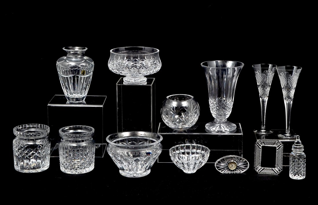 13 PIECE WATERFORD CRYSTAL COLLECTION: 13 PIECE WATERFORD CRYSTAL COLLECTION: Comprising; 2- tall champagne glasses, 1- picture frame, 1- clock, 1- baby bottle, 4 bowls, 2- vases, 2- biscuit jars with no lids. Largest Approx. 10" h x 6.5" 