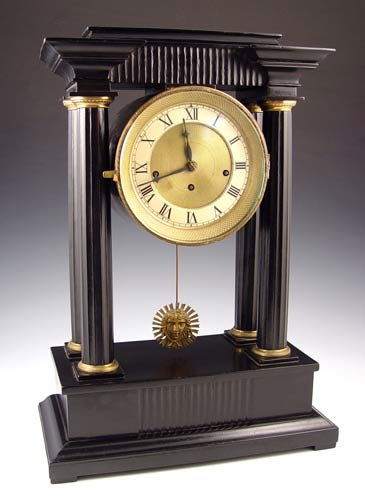 EMPIRE PILLAR MANTLE CLOCK GRAND SONNERIE MOVEMEN: EMPIRE PORTICO MANTLE CLOCK GRAND SONNERIE MOVEMENT: Empire style black painted wood base, columns and pediment. Brass face with Roman numerals. Grand sonnerie, key and pendulum movement. Unmarked as