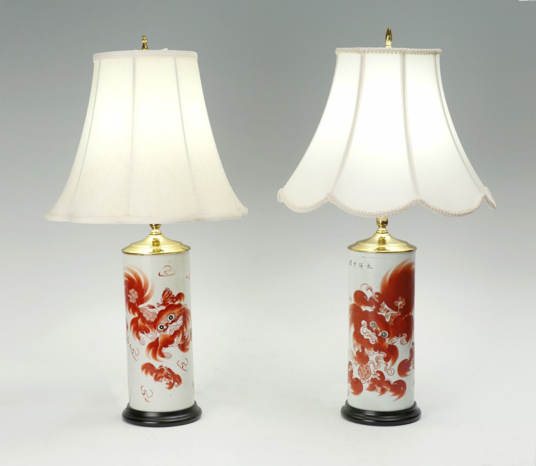 PAIR OF CHINESE OPPOSING FOO DOG LAMPS: PAIR OF CHINESE OPPOSING FOO DOG LAMPS: 2 early 20th- late 19th C. Chinese opposing porcelain white ground vases having hand painted Iron red male & female Foo Dogs. Both have poems in Kanji at the ve