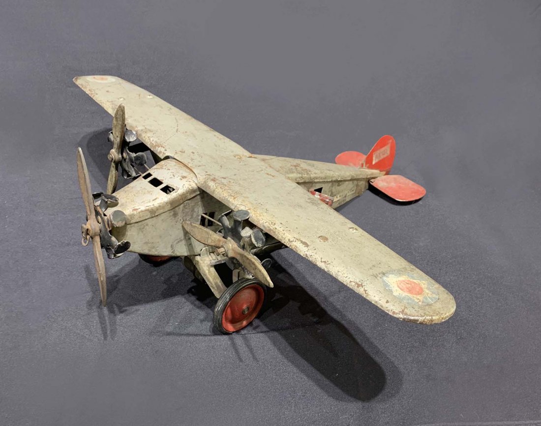 STEELCRAFT MECHANICAL PRESSED STEEL TOY US MAIL PLANE: STEELCRAFT MECHANICAL PRESSED STEEL TOY US MAIL PLANE: Pressed steel U.S. Army mail plane with 3 engines. Approx. 8.25" h x 23.5" l x 26.25" w.