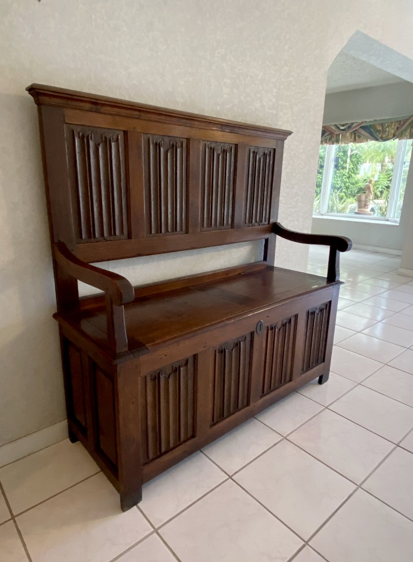 ANTIQUE 17TH C. EUROPEAN OAK SETTEE: ANTIQUE 17TH C. EUROPEAN OAK SETTEE: French 17th C. Oak settee, having carved linen fold inset panels, scrolling knuckles. Seat opens to reveal a storage area. Listed in Benezets. Approx. 53.75" h x 4