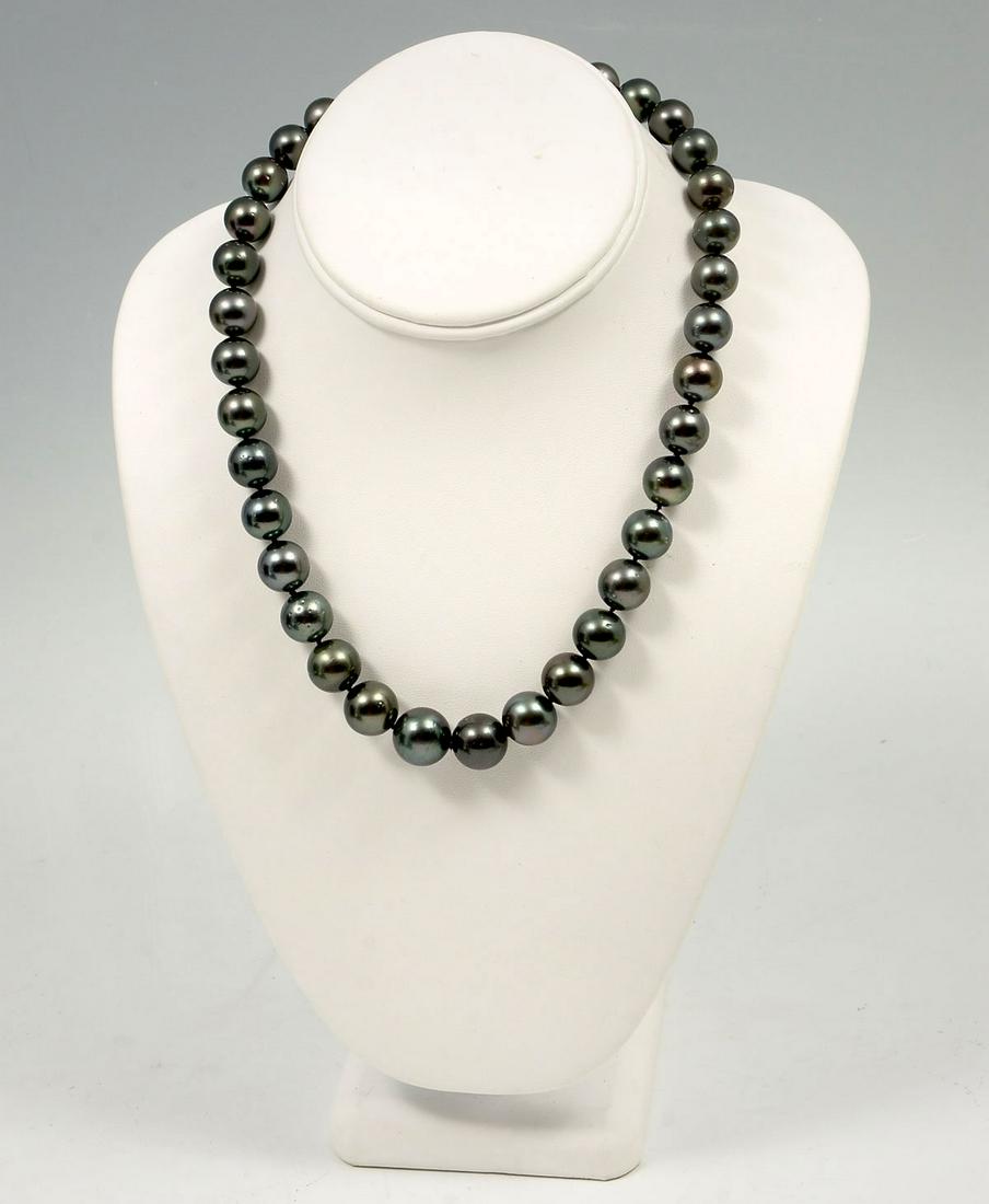BLACK SOUTH SEA PEARL NECKLACE: BLACK SOUTH SEA PEARL NECKLACE: Single strand of graduated cultured Tahitian Pearls with each pearl individually hand knotted. 18'' in length and finished with 14K white gold clasp. 35 pearls measure 
