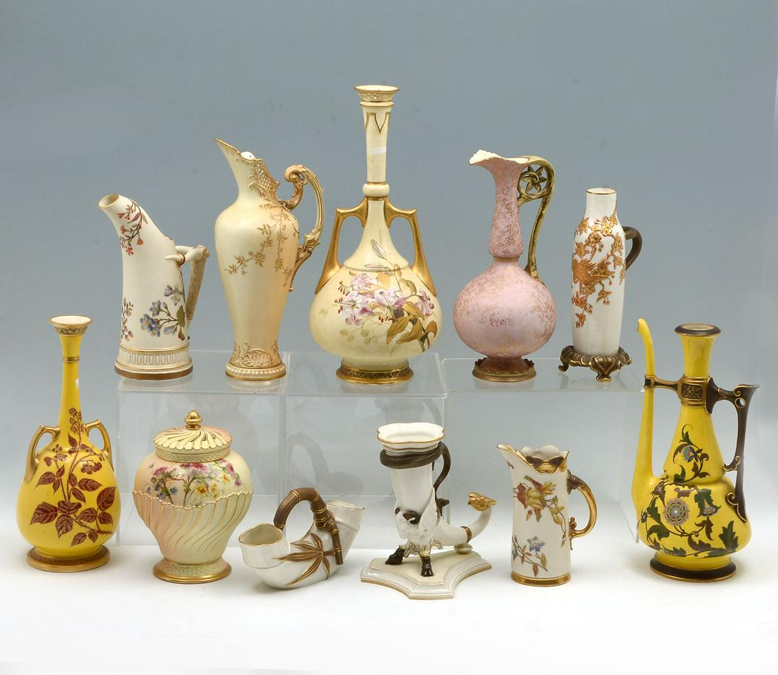 11 PC. ROYAL WORCESTER EWERS, PITCHERS, & VASES: 11 PC. ROYAL WORCESTER EWERS, PITCHERS, & VASES: Comprising; 1- yellow ground pitcher, 1- pierced foliate pitcher, 1- pitcher with a log form handle, 1- covered jar with a pierced lid, 1- bamboo handl