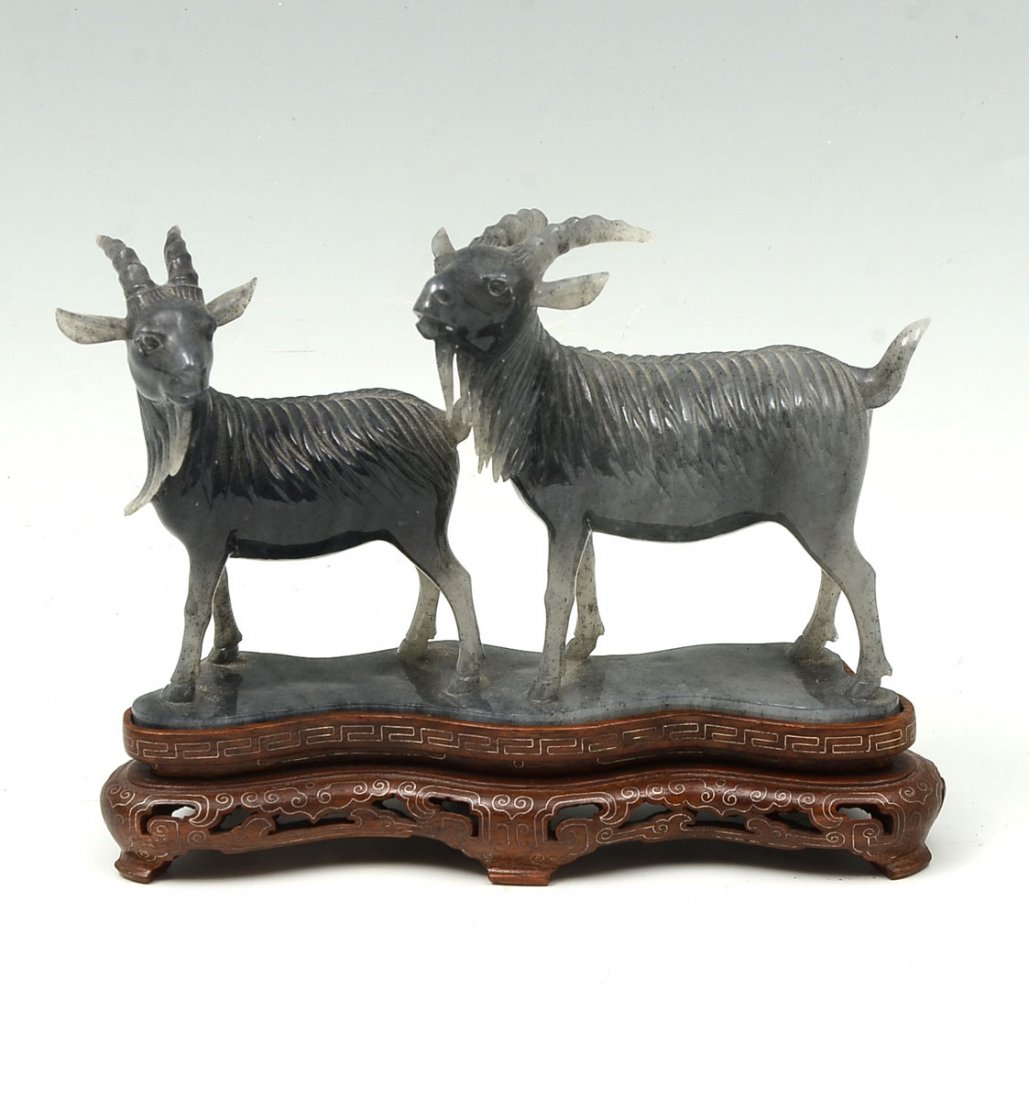 GREY TRANSLUCENT BURMESE JADEITE GOATS: GREY TRANSLUCENT BURMESE JADEITE GOATS: Carved Chinese Grey Nephrite in the form of 2 standing goats on a contoured foot. Also included is a contoured pierced wood base with inlaid Silver wire work. A