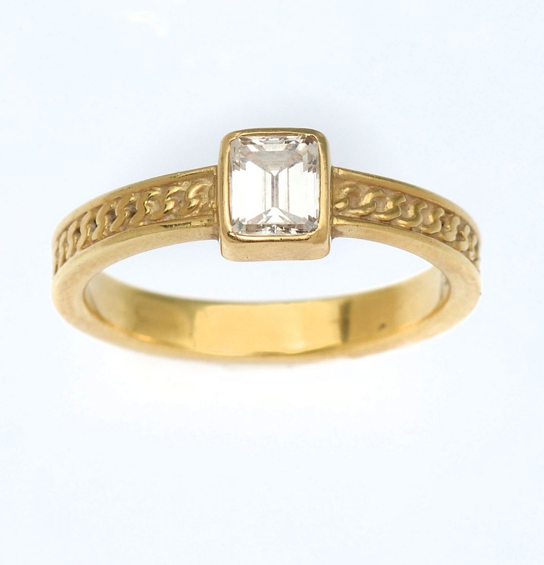 18K .50 CTW DIAMOND RING: 18K .50 CTW DIAMOND RING: 18K yellow gold diamond ring contains one emerald cut diamond. WEIGHT: .50 Ct. Approx. VS1 in clarity and G in color. The diamond is bezel set. Weight: 4.2 grams. Size: 8