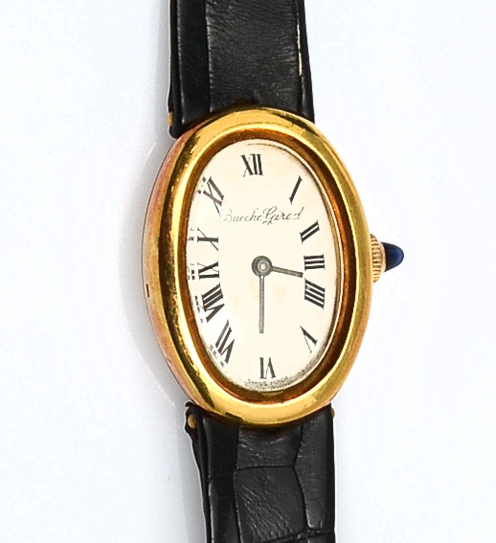 18K VINTAGE BUECCHE GIROD WATCH: 18K VINTAGE BUECCHE GIROD WATCH: Handsome retro style watch with off white dial and black Roman numeral hour markers in 18K yellow gold case with black lizard band. Manual wind. Watch case is marked Y