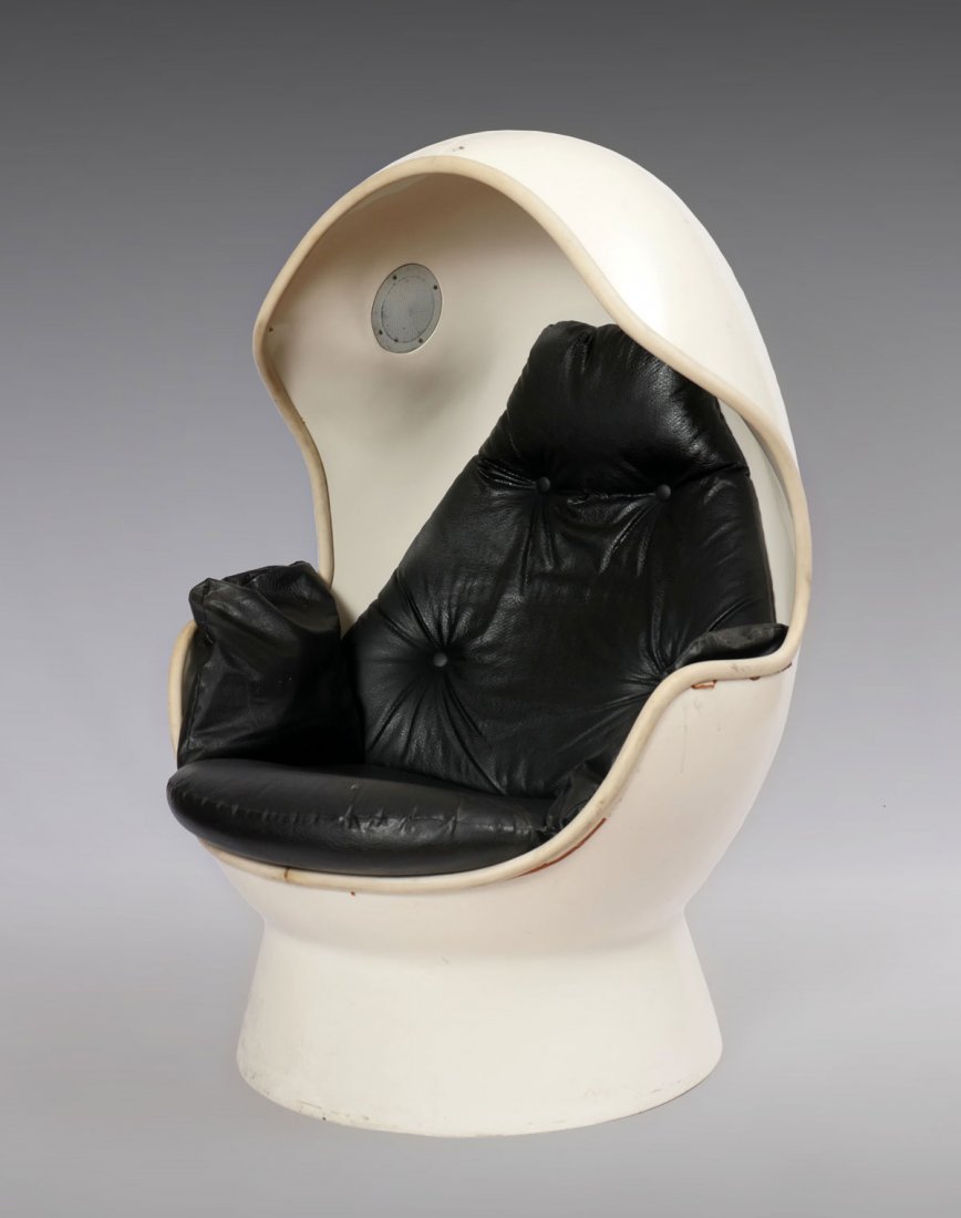MID-CENTURY MODERN MOLDED PLASTIC EGG CHAIR: MID-CENTURY MODERN MOLDED PLASTIC EGG CHAIR: An MCM white molded plastic egg chair with two speakers, audio inputs and black cushioned seat and back. 59''h, 34''w.